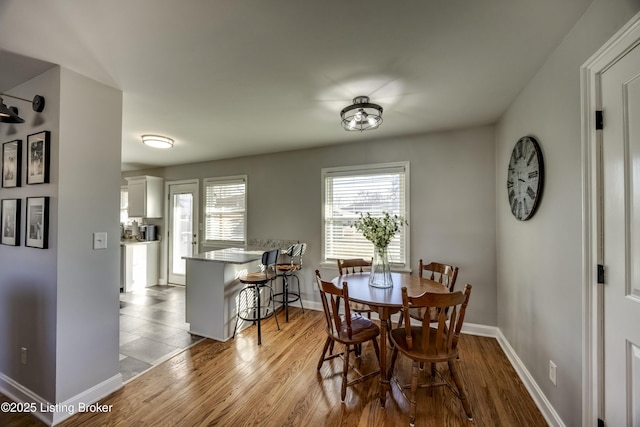 dining area with light hardwood / wood-style floors