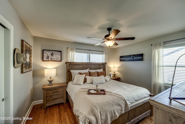 bedroom with ceiling fan and dark hardwood / wood-style floors