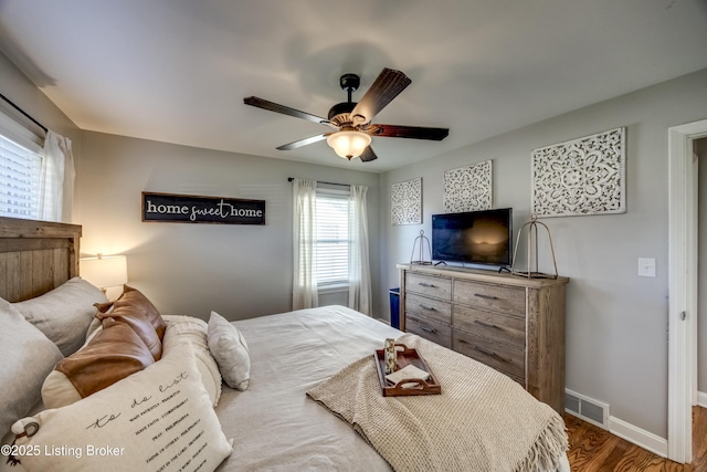 bedroom with ceiling fan and hardwood / wood-style flooring