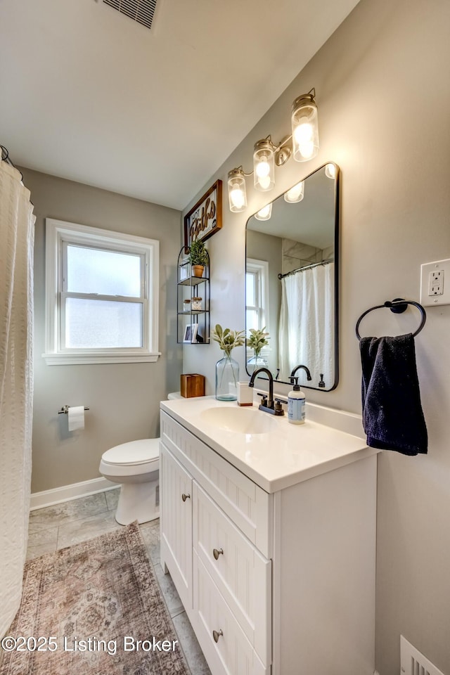 bathroom with tile patterned floors, vanity, and toilet