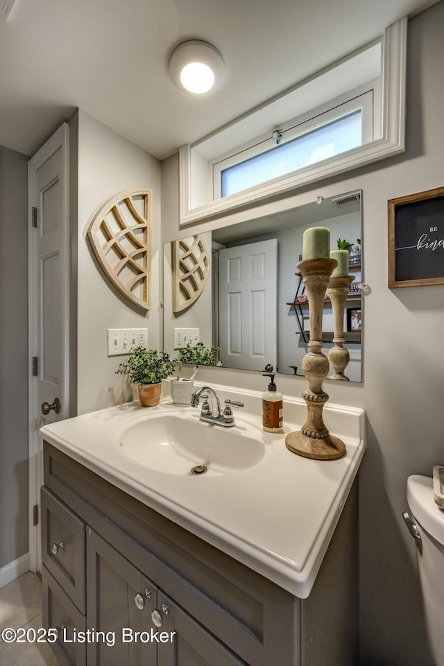 bathroom with tile patterned floors, vanity, and toilet