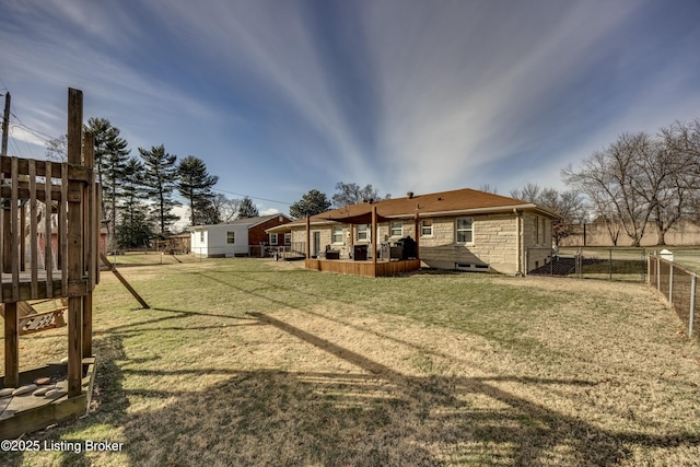 rear view of property featuring a lawn