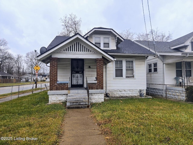 bungalow with covered porch and a front lawn