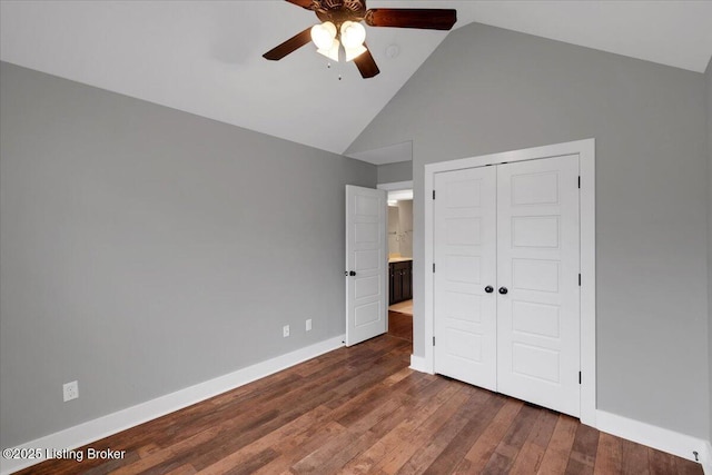 unfurnished bedroom with ceiling fan, dark wood-type flooring, a closet, and high vaulted ceiling