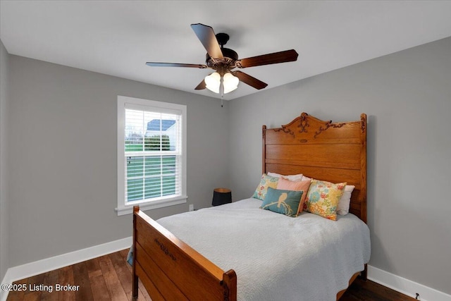 bedroom featuring ceiling fan, dark hardwood / wood-style flooring, and multiple windows