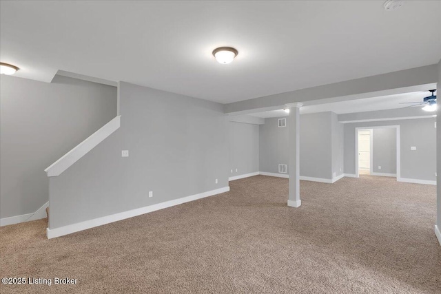 basement with carpet floors and ceiling fan