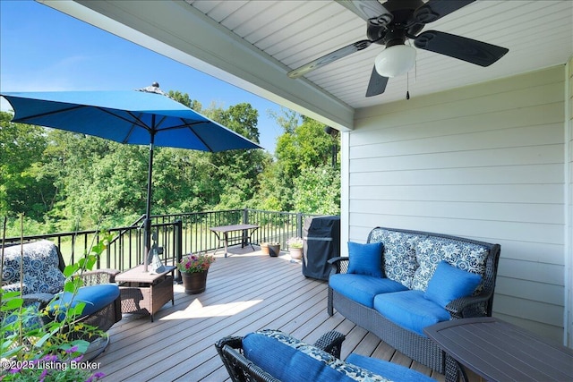 deck featuring grilling area, ceiling fan, and outdoor lounge area