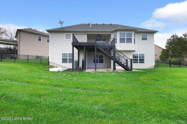 back of house featuring ceiling fan, a patio, a wooden deck, and a lawn