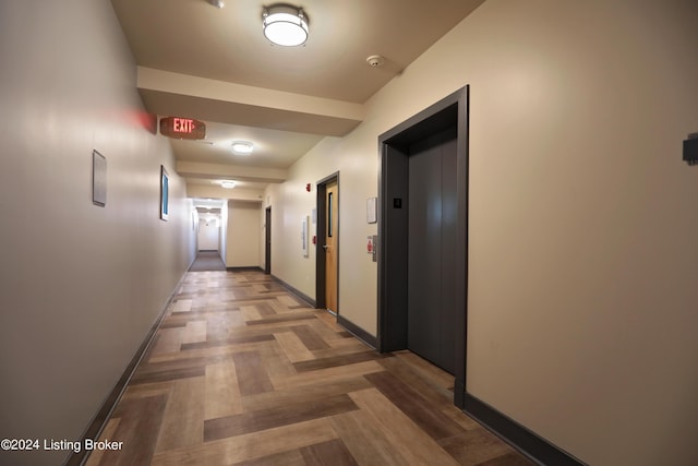 hallway featuring parquet floors and elevator