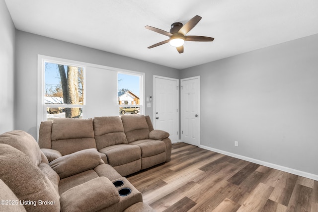 living room featuring ceiling fan and hardwood / wood-style floors