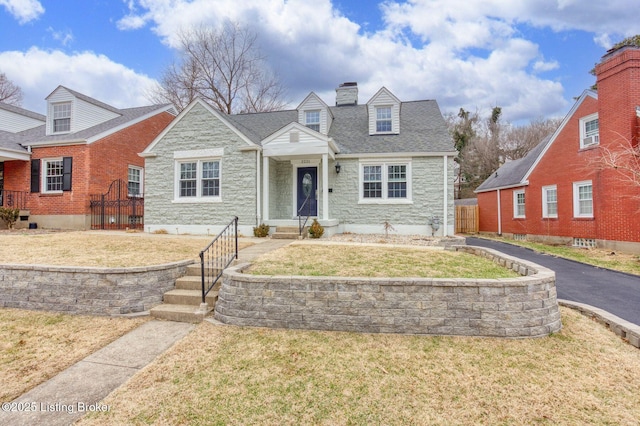 new england style home with a front lawn