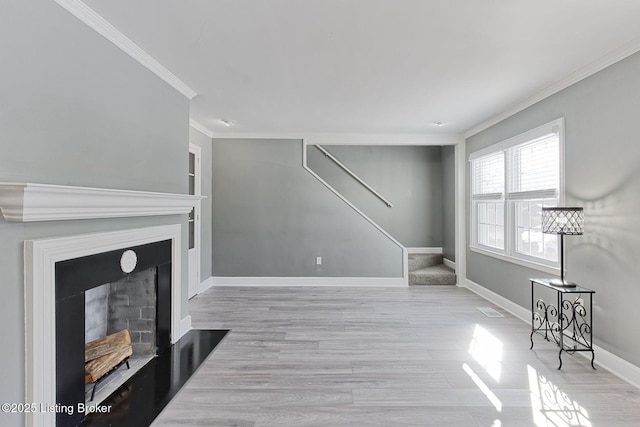 living room with crown molding and light hardwood / wood-style flooring