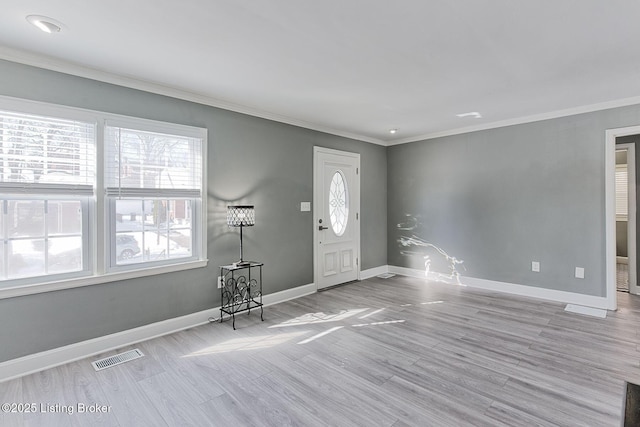 entryway with crown molding and light hardwood / wood-style flooring