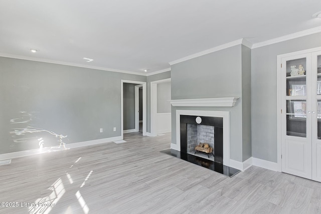 unfurnished living room featuring light hardwood / wood-style flooring and ornamental molding