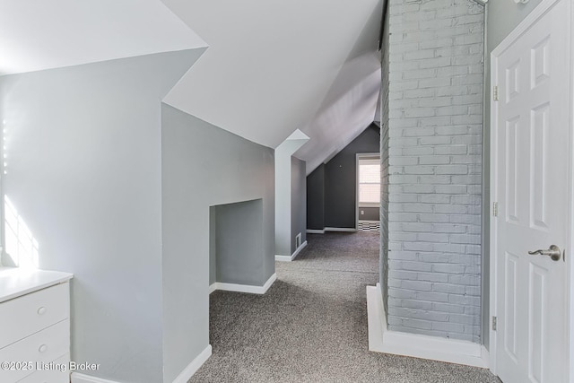 corridor featuring vaulted ceiling and carpet floors