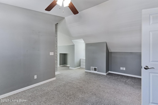 additional living space with ceiling fan, vaulted ceiling, and light carpet