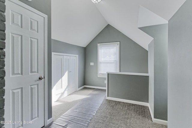 additional living space featuring lofted ceiling and carpet