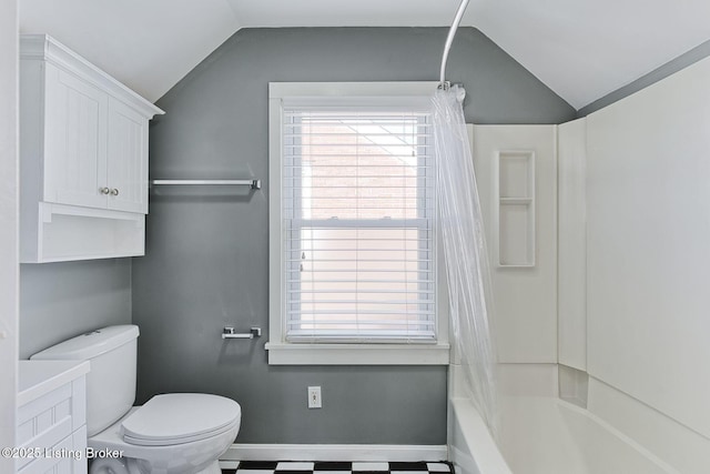 bathroom with shower / bath combination with curtain, lofted ceiling, and toilet