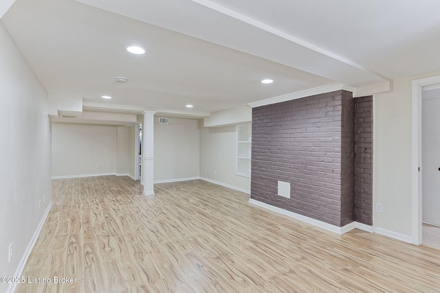 basement with built in shelves and light wood-type flooring