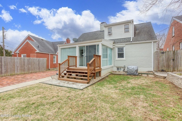 rear view of property with a lawn