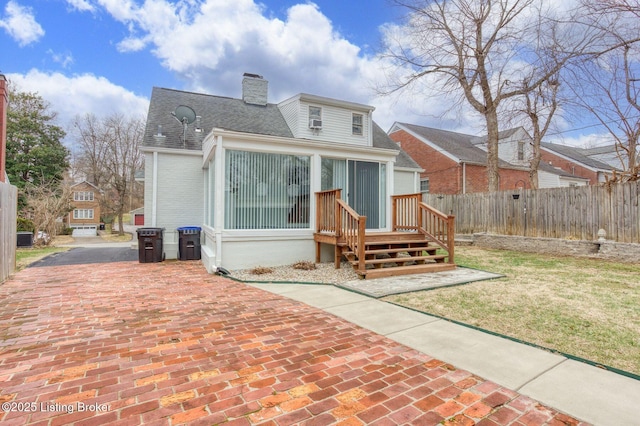 rear view of property with a lawn