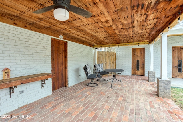 interior space with ceiling fan