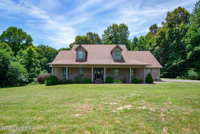 cape cod home with a porch and a front lawn