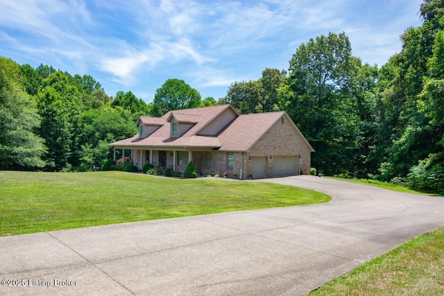 view of front of property featuring a garage and a front lawn