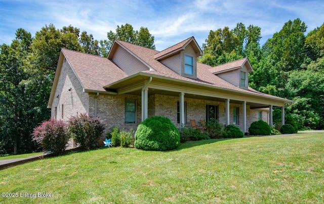 view of front of house featuring covered porch and a front yard