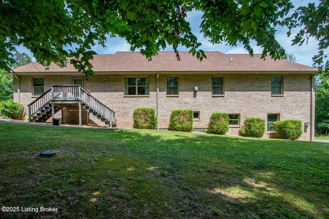 rear view of house featuring a lawn