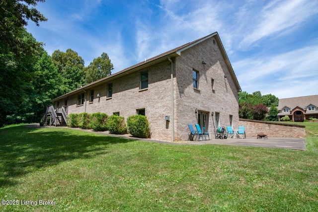 exterior space with a lawn and a patio