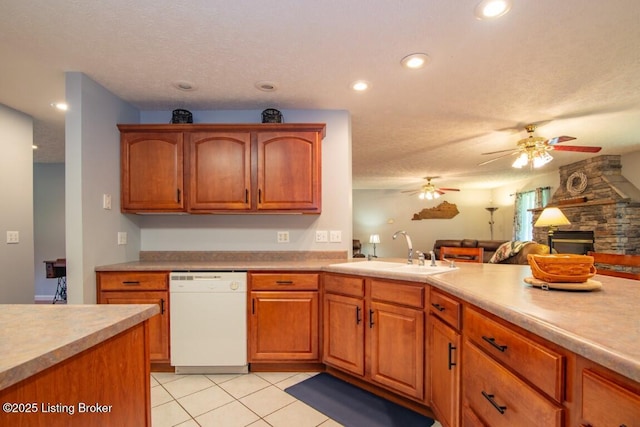 kitchen with dishwasher, light tile patterned floors, ceiling fan, a textured ceiling, and sink