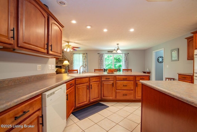 kitchen with sink, white appliances, light tile patterned flooring, ceiling fan, and kitchen peninsula