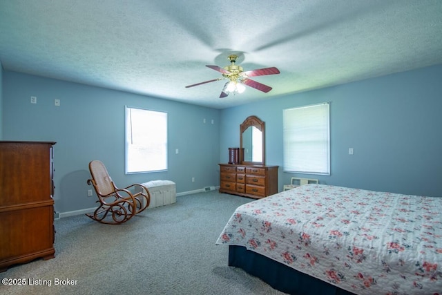 carpeted bedroom with a textured ceiling and ceiling fan