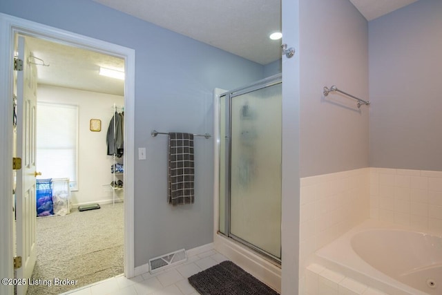 bathroom featuring tile patterned flooring and shower with separate bathtub