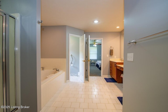 bathroom featuring tile patterned flooring, separate shower and tub, and vanity