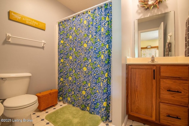 bathroom with walk in shower, vanity, and toilet