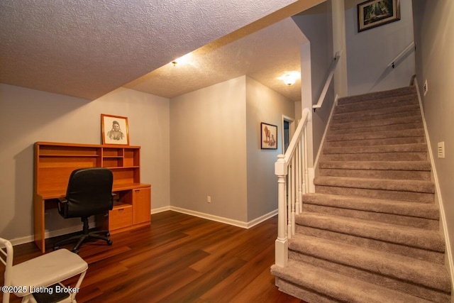 office space with a textured ceiling and dark hardwood / wood-style flooring