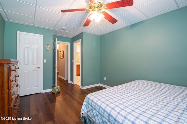 bedroom with ceiling fan, a paneled ceiling, and dark hardwood / wood-style floors