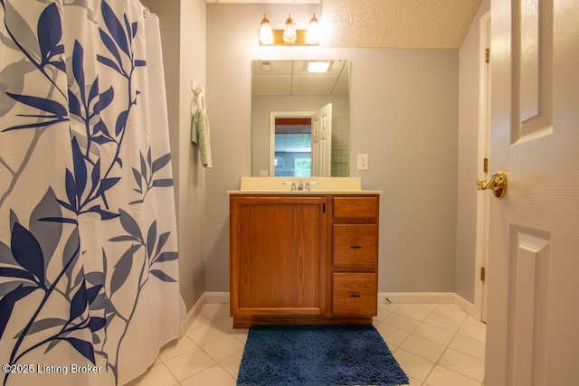 bathroom with vanity, tile patterned floors, and a textured ceiling