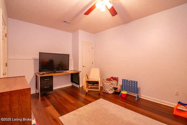 interior space featuring ceiling fan and dark hardwood / wood-style floors