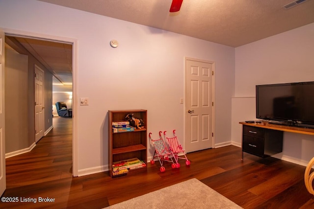 game room featuring ceiling fan and dark wood-type flooring