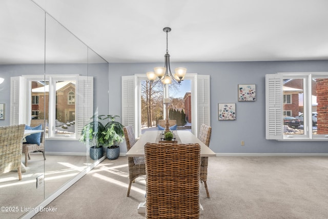 carpeted dining space featuring an inviting chandelier