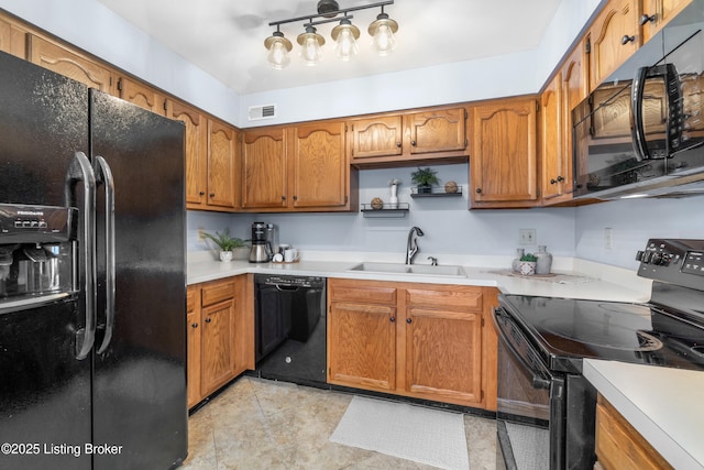 kitchen with sink, light tile patterned floors, and black appliances