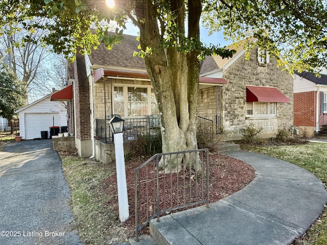 view of front of home with a garage and an outdoor structure