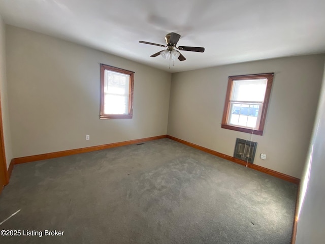 unfurnished room with ceiling fan and carpet