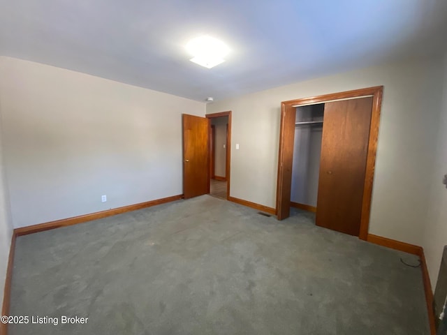 unfurnished bedroom with carpet and a closet