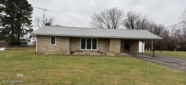 view of front of property with a front lawn and a carport