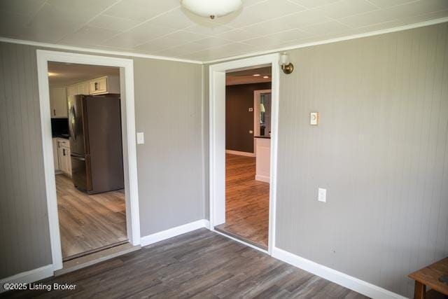 interior space featuring black fridge, dark hardwood / wood-style flooring, and a closet