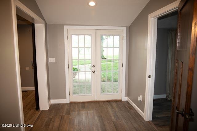 doorway with french doors, vaulted ceiling, and dark hardwood / wood-style floors